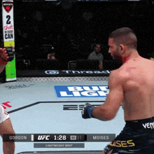 a boxing match between gordon and moises is being shown on the screen