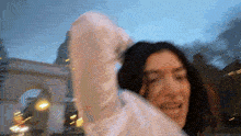 a blurry picture of a woman in a white sweater