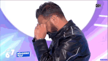 a man covering his face with his hands in front of a sign that says " reagissez # 67 "