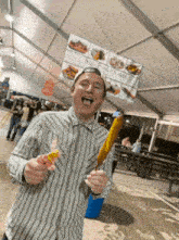 a man is holding a corn on the cob in front of a sign that says salt funky cakes