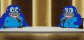 two blue cartoon gorillas sit at a table with microphones