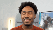a man sitting in a chair with his eyes closed and a poster in the background that says run
