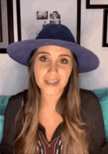 a woman wearing a purple hat and a black shirt