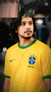 a man in a yellow shirt with the word brasil on it