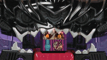 a close up of a toy robot with a purple and red stripe on the head