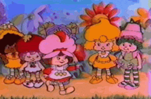 a group of strawberry shortcake dolls standing next to each other