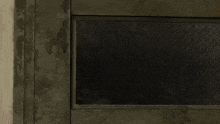 a cartoon wolf is peeking out of a doorway and looking at the camera .
