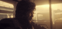 a man smoking a cigarette on a bus