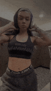 a woman with purple hair is wearing a sports bra that says witch on it