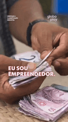 a stack of money with the words eu sou empreendedor on it