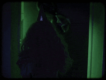 a woman in a party hat is standing in front of a mirror