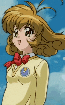 a girl in a yellow uniform with a red bow
