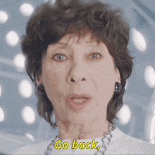 an elderly woman says " go back " in a video