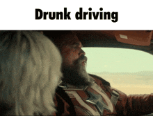 a man with a beard is driving a car with the words " drunk driving " below him