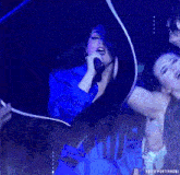 a woman singing into a microphone with the words edits portirroni on the bottom right