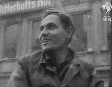 a man is smiling in front of a sign that says bitterhoffs nor