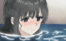 a girl is taking a bath in the ocean and looking at the camera