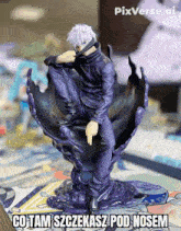 a statue of a man sitting on a purple object with pixverse.ai written in the corner