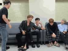 a group of young men are sitting on a couch with the number 454,576 on the bottom right