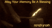 a candle is lit with the words may your memory be a blessing above it