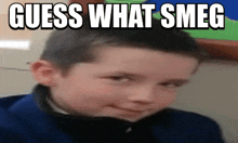 a young boy is making a funny face with the words guess what smeg written above him