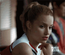 a cheerleader from fox 41 wdrb sits in a classroom