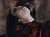 a close up of a woman laying down with her head up