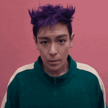 a man with purple hair wearing a green jacket