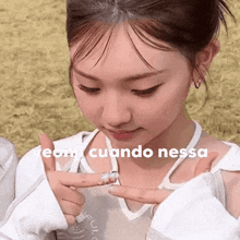 a close up of a woman 's face with the words cuando nessa on the bottom .
