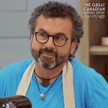 a man with glasses and a beard is featured on the great canadian baking show poster