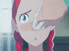 a person wipes a girl 's face with a napkin