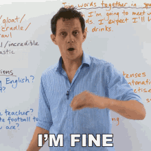 a man stands in front of a white board with the words " i 'm fine " on it