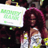 a woman with red hair is holding a briefcase that says money bank on it