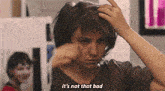 a woman is touching her hair and saying it 's not that bad .