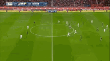 a soccer game is being played on a field with advertisements for adidas and aek