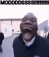 a man is making a funny face with his mouth open and his tongue out .