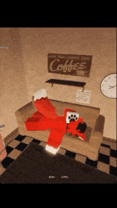 a red fox is laying on a couch with a coffee sign above it