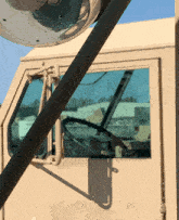 a military vehicle has a steering wheel and a mirror