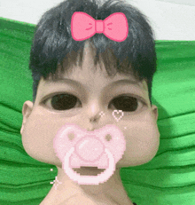 a person with a pacifier in their mouth and a pink bow on their head