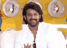 a man with a beard wearing sunglasses and a white shirt