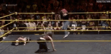 two wrestlers are wrestling in a ring with a crowd watching and the words wwe nxt on the bottom right