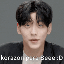 a close up of a man 's face with the words korazon para beee : d written below him