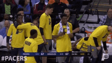 a group of pacers players are huddled together