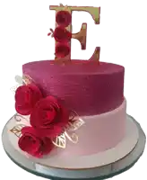 a pink cake with a letter e on top of it