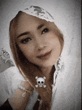 a girl with a skull and crossbones necklace