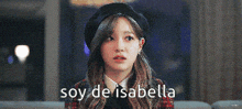 a woman wearing a black beret and a plaid jacket says soy de isabella