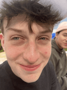 a close up of a man 's face with a hat on