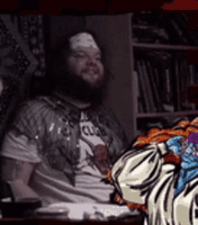 a man with a bandage on his forehead is sitting in front of a zebra