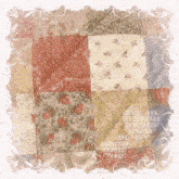a quilt with flowers and swirls in the corner