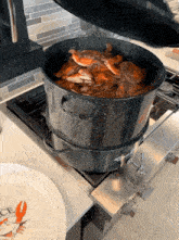a pot of crabs is being cooked on a stove top